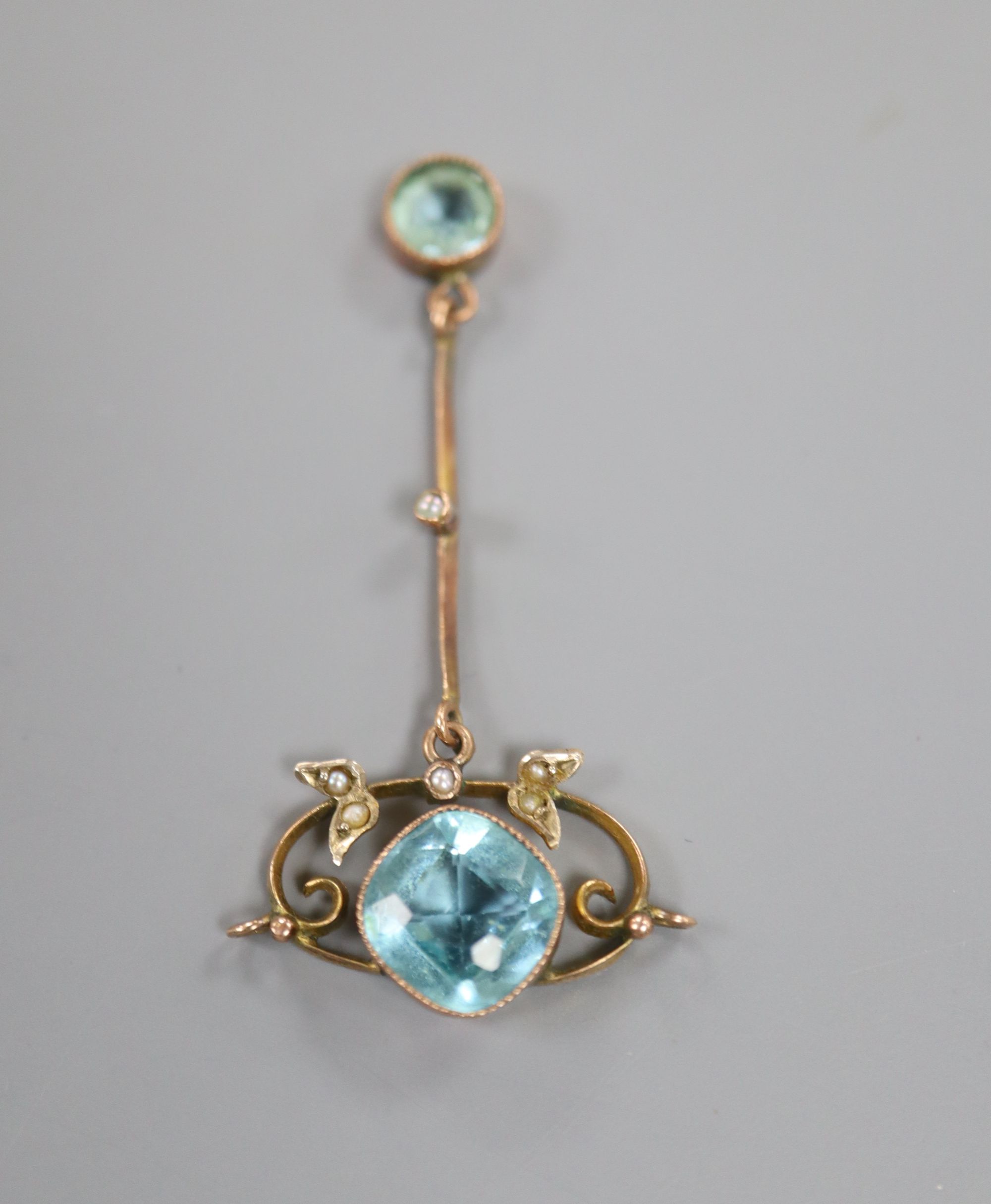 An early 20th century yellow metal, seed pearl and two stone blue topaz set drop pendant, 45mm, gross 2.4 grams.